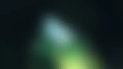 Soft aurora glow of pale cyan, green and lime over near-black background
