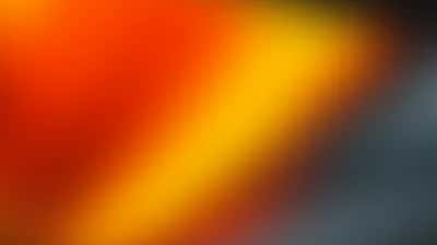 Diagonal gradient blending fiery orange and golden amber into cool slate gray