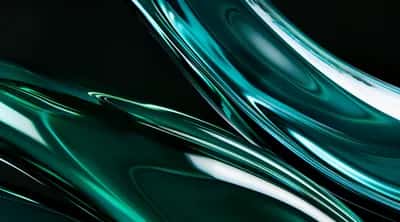 Flowing dark emerald glass curves with bright white highlights against black