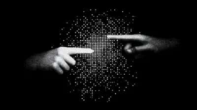 Two stippled white hands with index fingers nearly touching, formed from dots on black