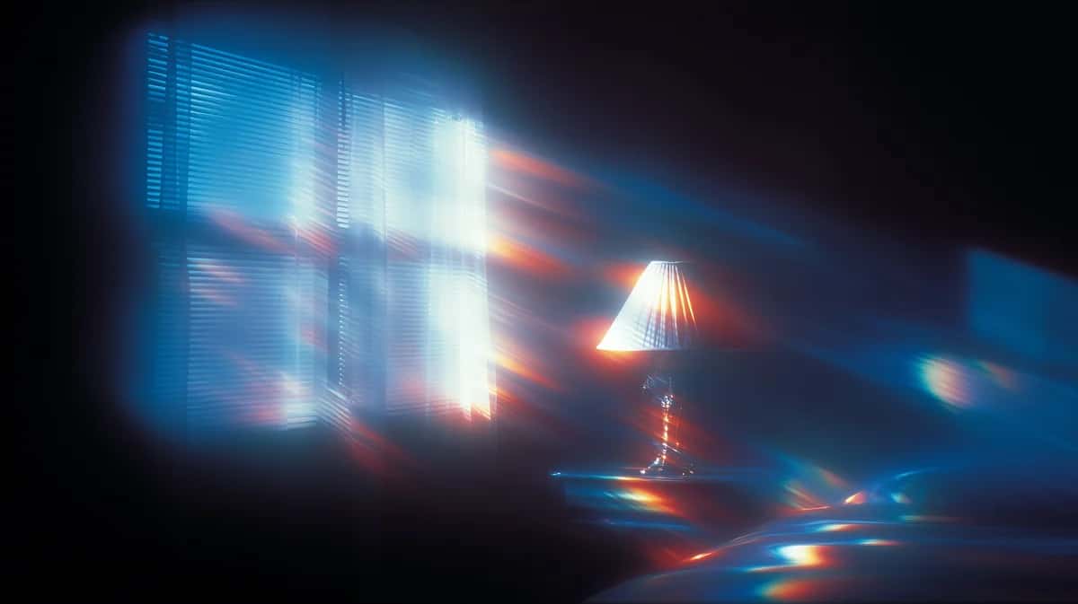 Abstract glowing lights with blue and orange tones, blurred motion effect, dark background