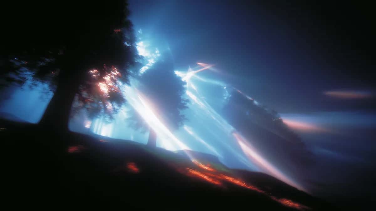 Silhouetted grove of trees with brilliant blue light beams streaming through the dark