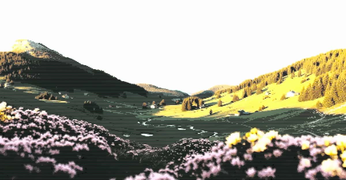 Pixelated alpine valley with green hills, pink wildflowers and golden slopes under a white sky