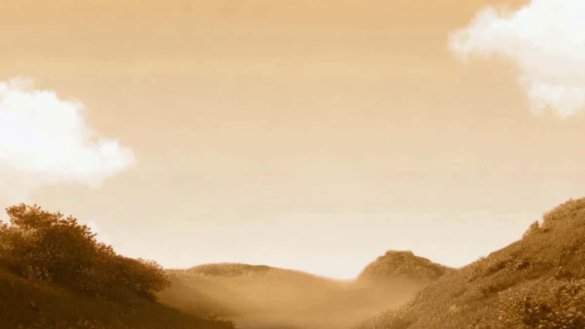 Golden mountain landscape with rolling hills, warm sepia tones, soft clouds, hazy atmospheric light