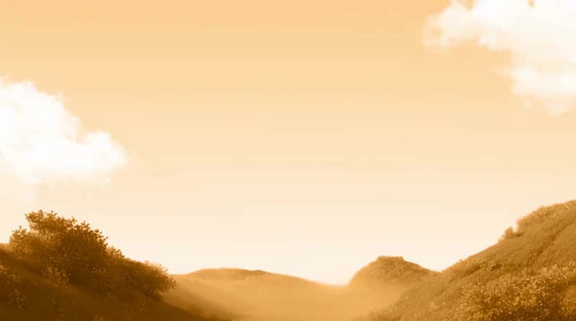 Golden sunset landscape with rolling hills, trees, and soft clouds in warm light